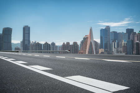 Asphalt road carriageway and city buildings landscapeの写真素材
