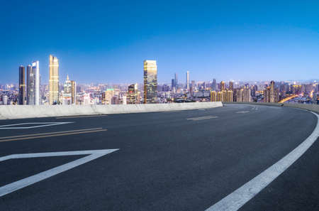 Asphalt road carriageway and city buildings landscapeの写真素材