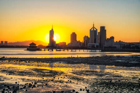 Aerial photography of Qingdao coastline bay area scenery at duskの写真素材