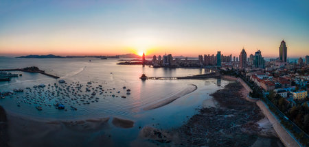 Aerial photography of Qingdao coastline bay area scenery at duskの写真素材