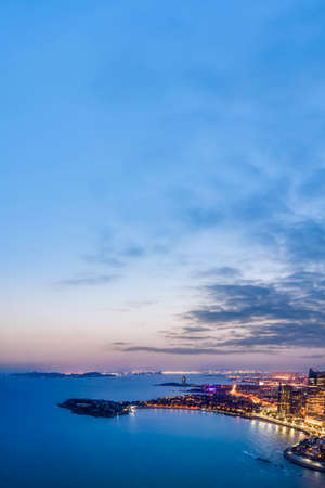 Aerial photography of Qingdao city coastline at nightの写真素材
