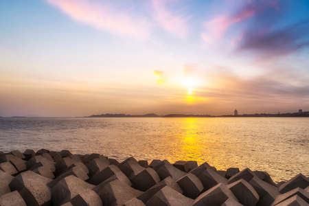 Outdoor sunset ocean seascape and breakwaterの写真素材