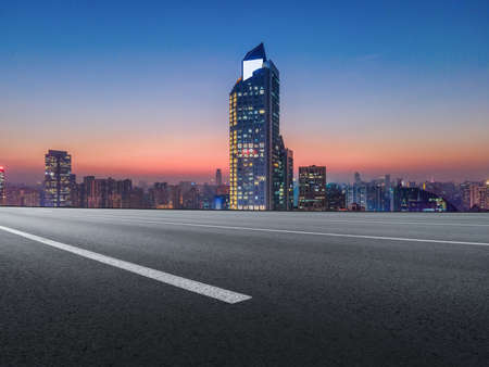 The road ahead and city buildings landscape night sceneの写真素材