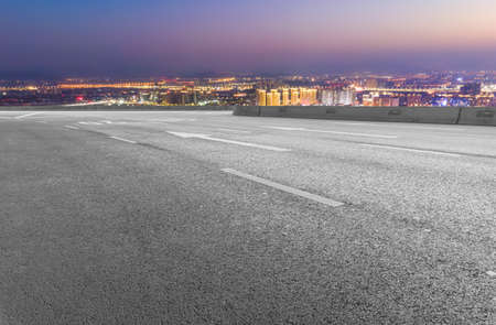 Night view of highway and financial district buildingsの写真素材