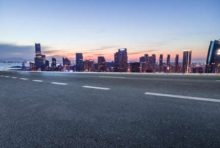 Night view of asphalt ground and city buildings landscape