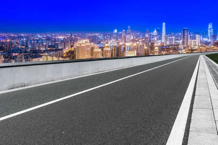 Night view of asphalt skyline and financial district buildingsの写真素材
