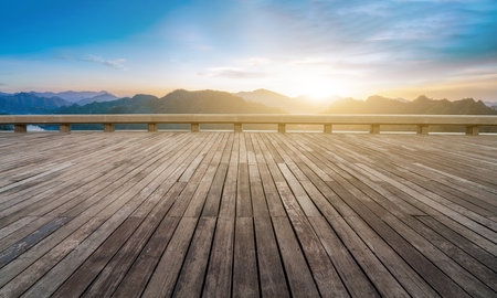 Wooden plank road viewing platform and distant mountain backgroundの写真素材