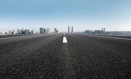 The road ahead and the city's financial district buildingsの写真素材