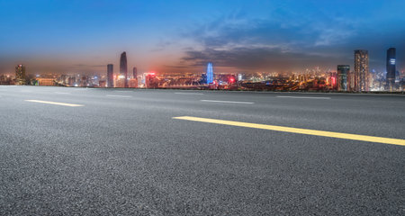 Night view of highway skyline and city modern buildingsの写真素材