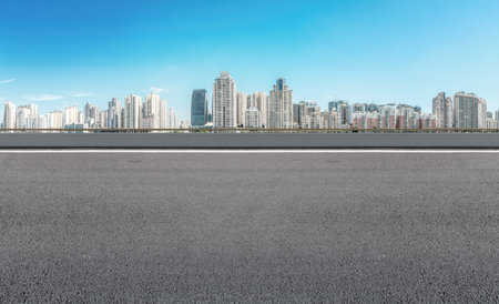 Asphalt road ground and urban modern buildingsの写真素材