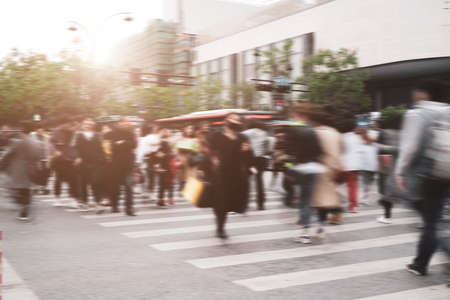 Crosswalk lines and blurred crowdの写真素材