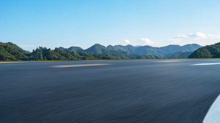 Empty asphalt road and mountain with blue sky, panoramic viewの写真素材