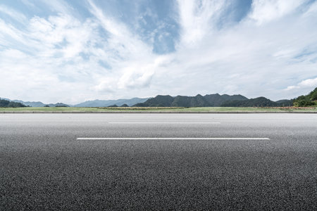 Asphalt road and mountain natural landscape under blue sky, panoramic viewの写真素材