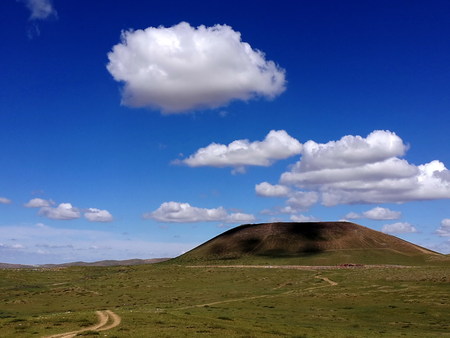 View of a mountain under the clouds and blue skyの写真素材