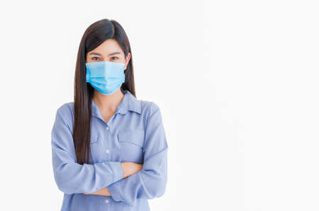 Portrait of young asian woman wearing medical protective face mask to protect infection from...