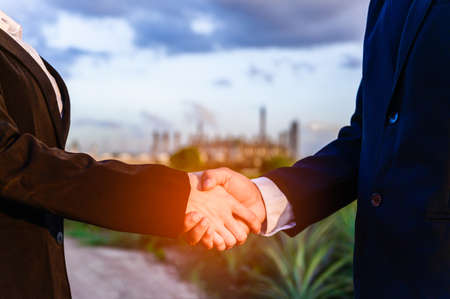 Businesspeople shaking hands after successful dealing and partnership. Bussiness and finance concept.の写真素材