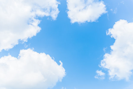 Blue sky and white fluffy clouds for background.の写真素材