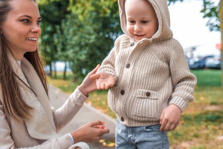 young family, woman mother little boy, holds an insect on his hand, ladybug on his hand, warm...
