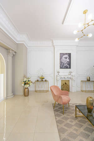 chic luxury interior in an old antique style open-plan apartment decorated with columns and stucco on the wall in pastel colors. tiles on the floor. beige wallsの写真素材