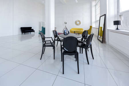 modern fashionable futuristic interior design of a spacious white hall with black and yellow furnitureの写真素材