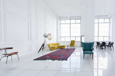 modern fashionable futuristic interior design of a spacious white hall with black and yellow furnitureの写真素材