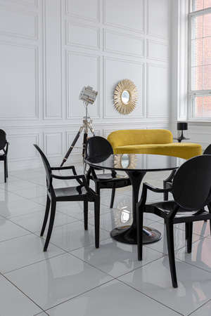 modern fashionable futuristic interior design of a spacious white hall with black and yellow...