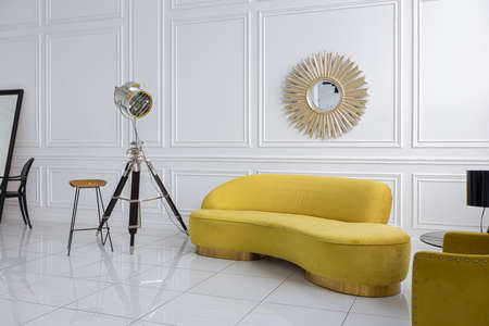 modern fashionable futuristic interior design of a spacious white hall with black and yellow furnitureの写真素材