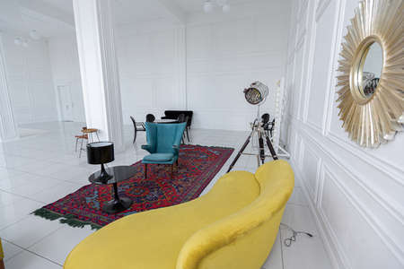 modern fashionable futuristic interior design of a spacious white hall with black and yellow furnitureの写真素材