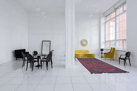 modern fashionable futuristic interior design of a spacious white hall with black and yellow furnitureの写真素材