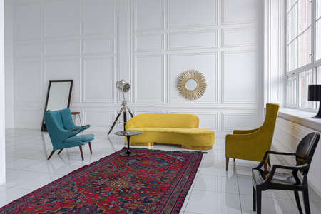 modern fashionable futuristic interior design of a spacious white hall with black and yellow furnitureの写真素材