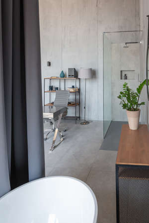 Modern minimalistic dark gray loft style studio apartment interior design. kitchen, sitting area,...