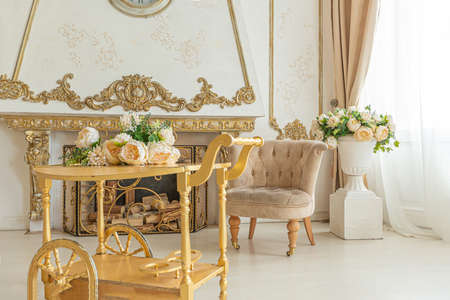 luxurious expensive interior of a large baroque royal living room. antique furniture, gold trim,...