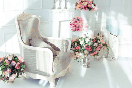 luxury clean bright white interior. a spacious room with sunlight and flowers in vasesの写真素材