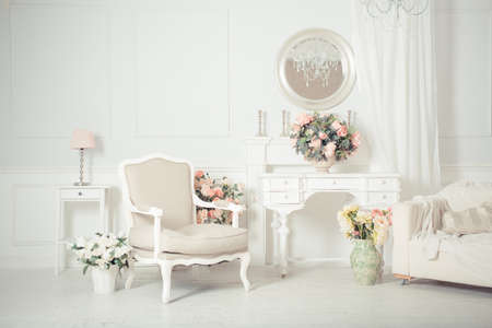 luxury clean bright white interior. a spacious room with sunlight and flowers in vasesの写真素材
