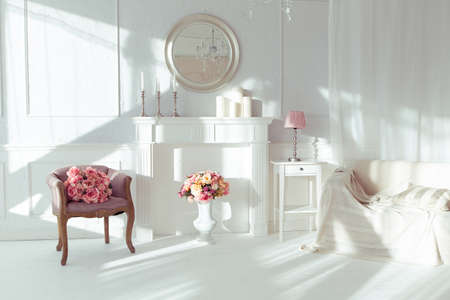 luxury clean bright white interior. a spacious room with sunlight and flowers in vasesの写真素材