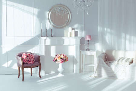 luxury clean bright white interior. a spacious room with sunlight and flowers in vasesの写真素材