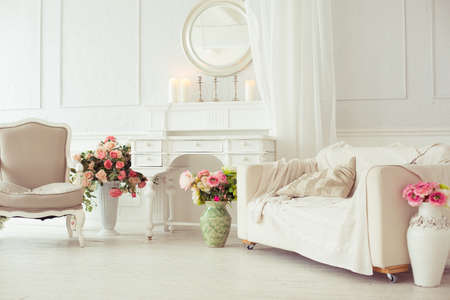 luxury clean bright white interior. a spacious room with sunlight and flowers in vasesの写真素材