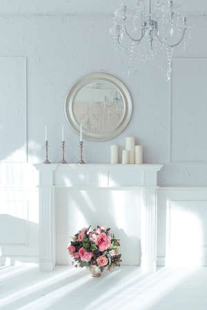 luxury clean bright white interior. a spacious room with sunlight and flowers in vasesの写真素材