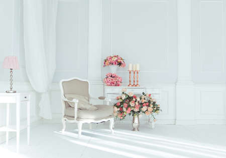 luxury clean bright white interior. a spacious room with sunlight and flowers in vasesの写真素材