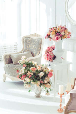 luxury clean bright white interior. a spacious room with sunlight and flowers in vasesの写真素材