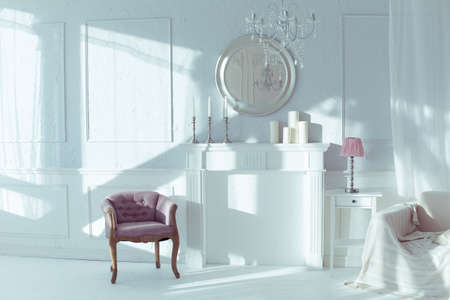 luxury clean bright white interior. a spacious room with sunlight and flowers in vasesの写真素材