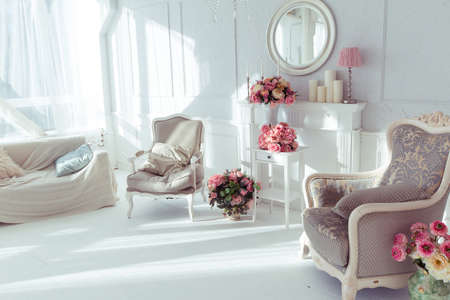 luxury clean bright white interior. a spacious room with sunlight and flowers in vasesの写真素材