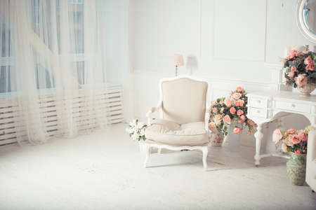 luxury clean bright white interior. a spacious room with sunlight and flowers in vasesの写真素材