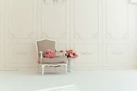 luxury clean bright white interior. a spacious room with sunlight and flowers in vasesの写真素材