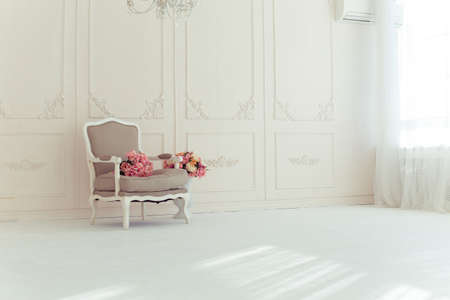 luxury clean bright white interior. a spacious room with sunlight and flowers in vasesの写真素材