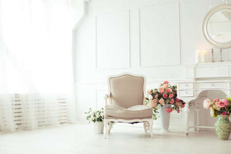 luxury clean bright white interior. a spacious room with sunlight and flowers in vasesの写真素材
