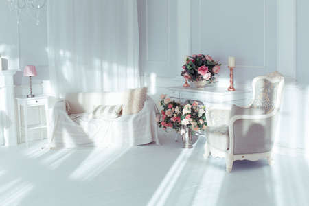 luxury clean bright white interior. a spacious room with sunlight and flowers in vasesの写真素材