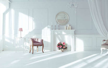 luxury clean bright white interior. a spacious room with sunlight and flowers in vasesの写真素材