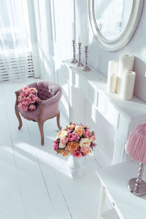 luxury clean bright white interior. a spacious room with sunlight and flowers in vasesの写真素材