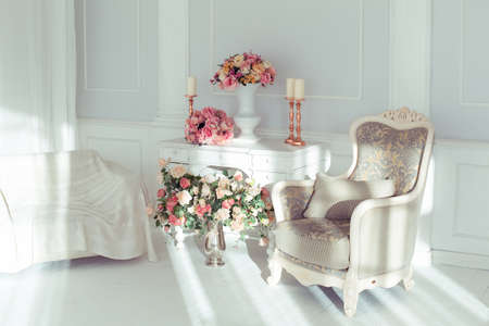 luxury clean bright white interior. a spacious room with sunlight and flowers in vasesの写真素材